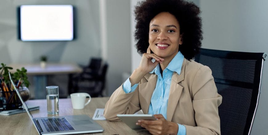 happy-african-american-businesswoman-working-touchpad-office